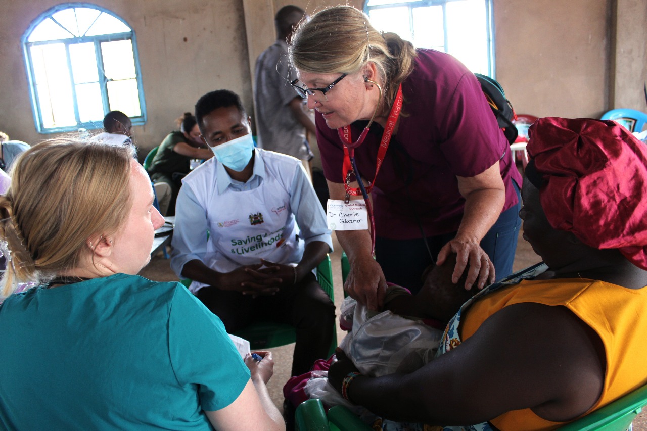 Visiting students and local health workers treating patients together during a clinical attachment