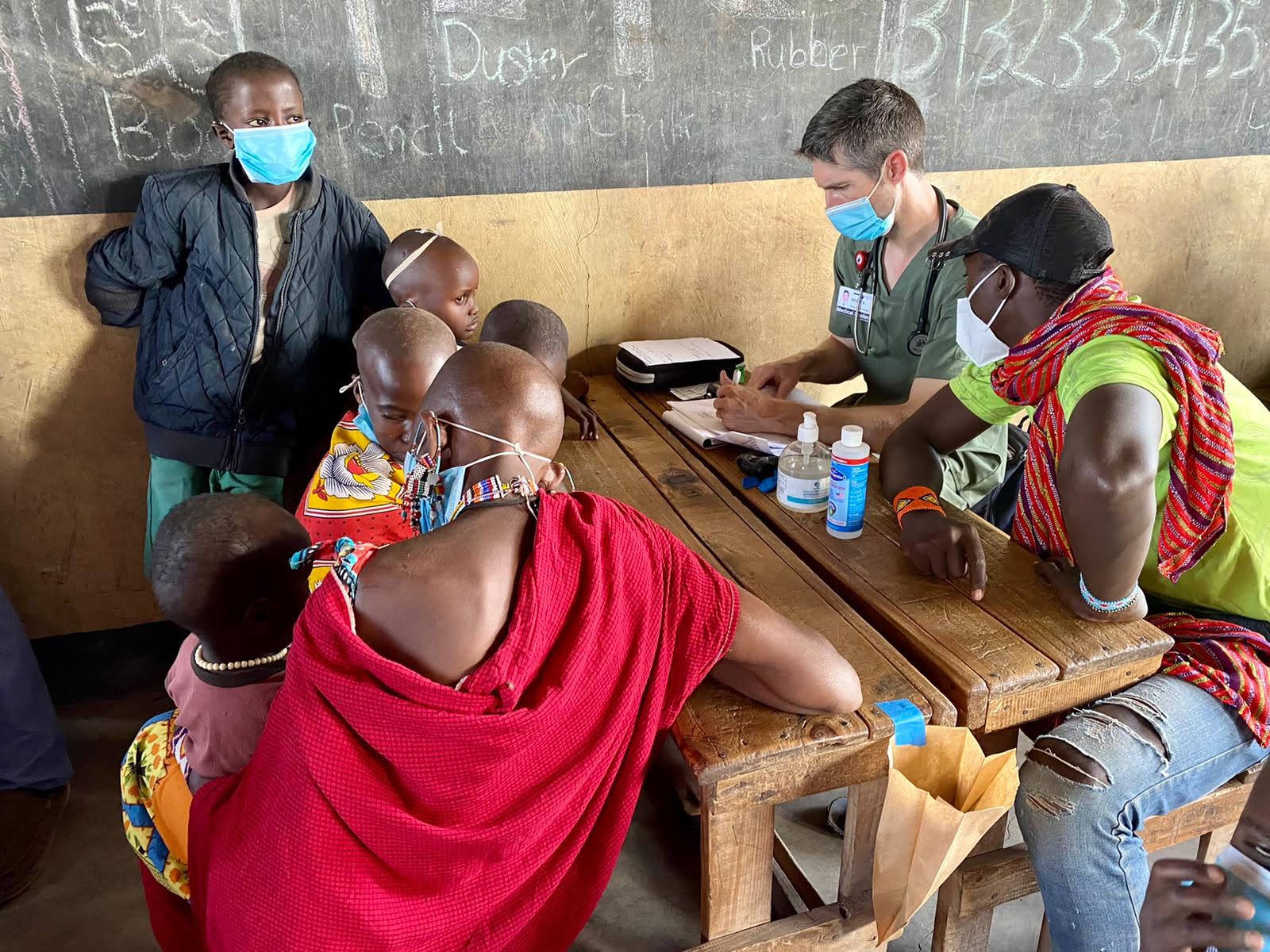 Clinicians consulting with patients at a village medical outreach